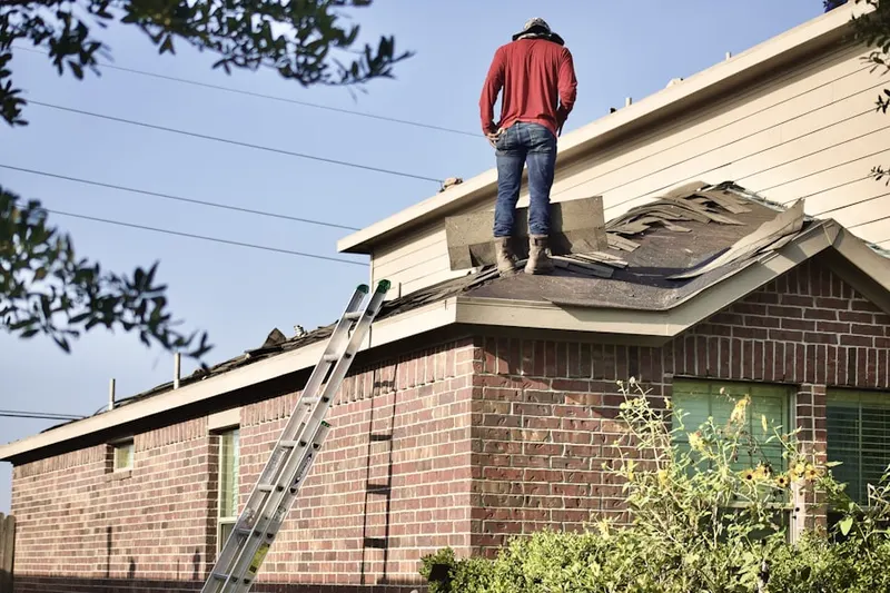 Professional roofer working on a residential roof in Colonie